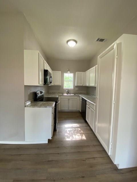 3113 Farm To Market Road 131 Denison, TX 75020 - Photo 4 of 11 a kitchen with granite countertop a refrigerator stove and white cabinets