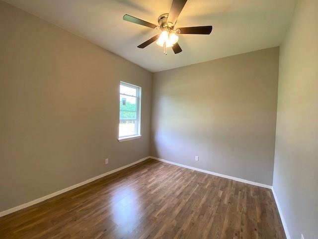 3113 Farm To Market Road 131 Denison, TX 75020 - Photo 7 of 11 an empty room with wooden floor and windows