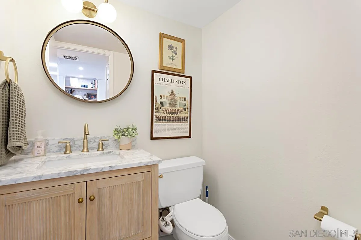 2383 Altisma Way, Unit B Carlsbad, CA 92009 - Photo 12 of 38 a bathroom with a toilet a sink and a mirror