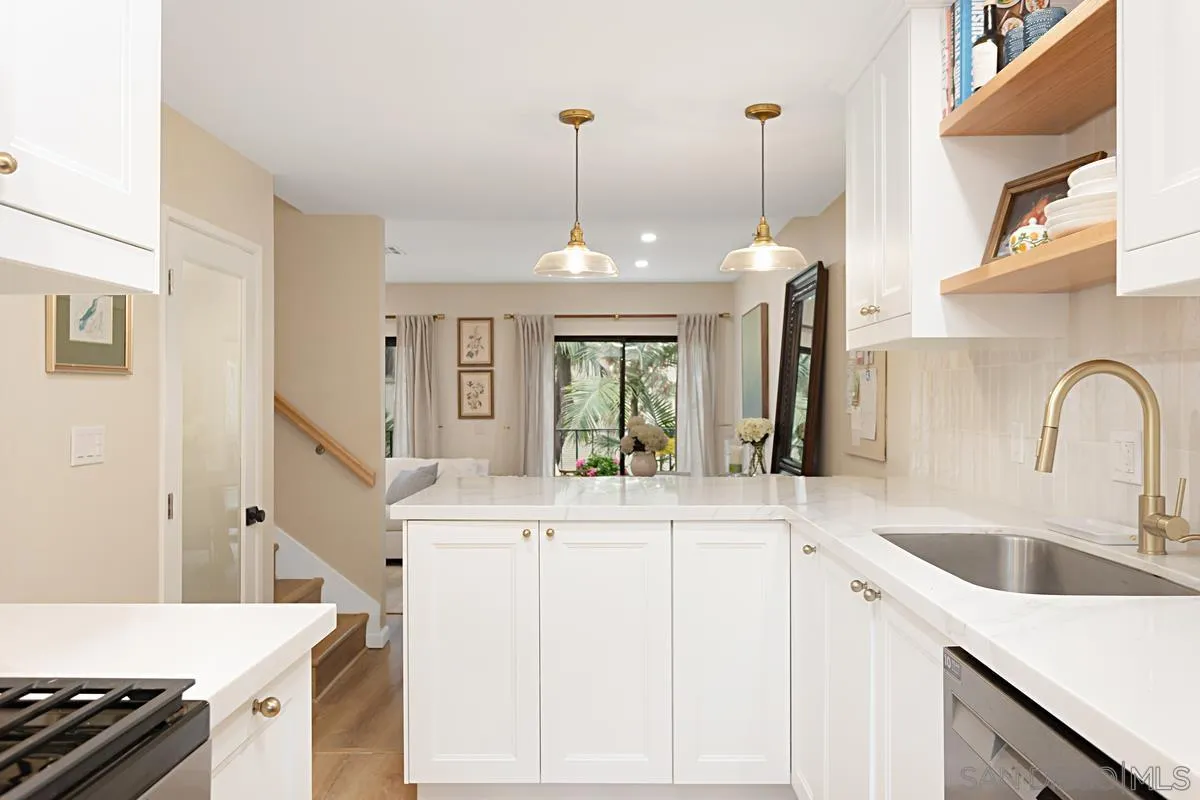 2383 Altisma Way, Unit B Carlsbad, CA 92009 - Photo 2 of 38 a kitchen with a sink stove and cabinets