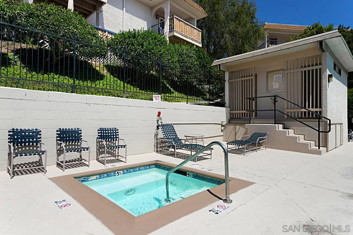 2383 Altisma Way, Unit B Carlsbad, CA 92009 - Photo 27 of 38 a view of a patio with a table and chairs and wooden fence