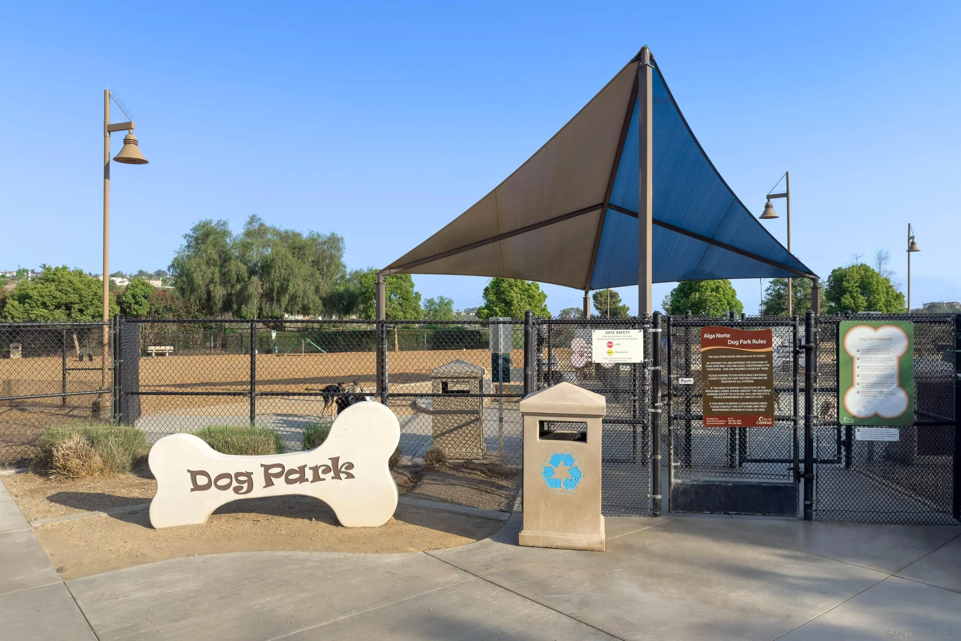 2383 Altisma Way, Unit B Carlsbad, CA 92009 - Photo 38 of 38 a patio with tables and chairs under an umbrella