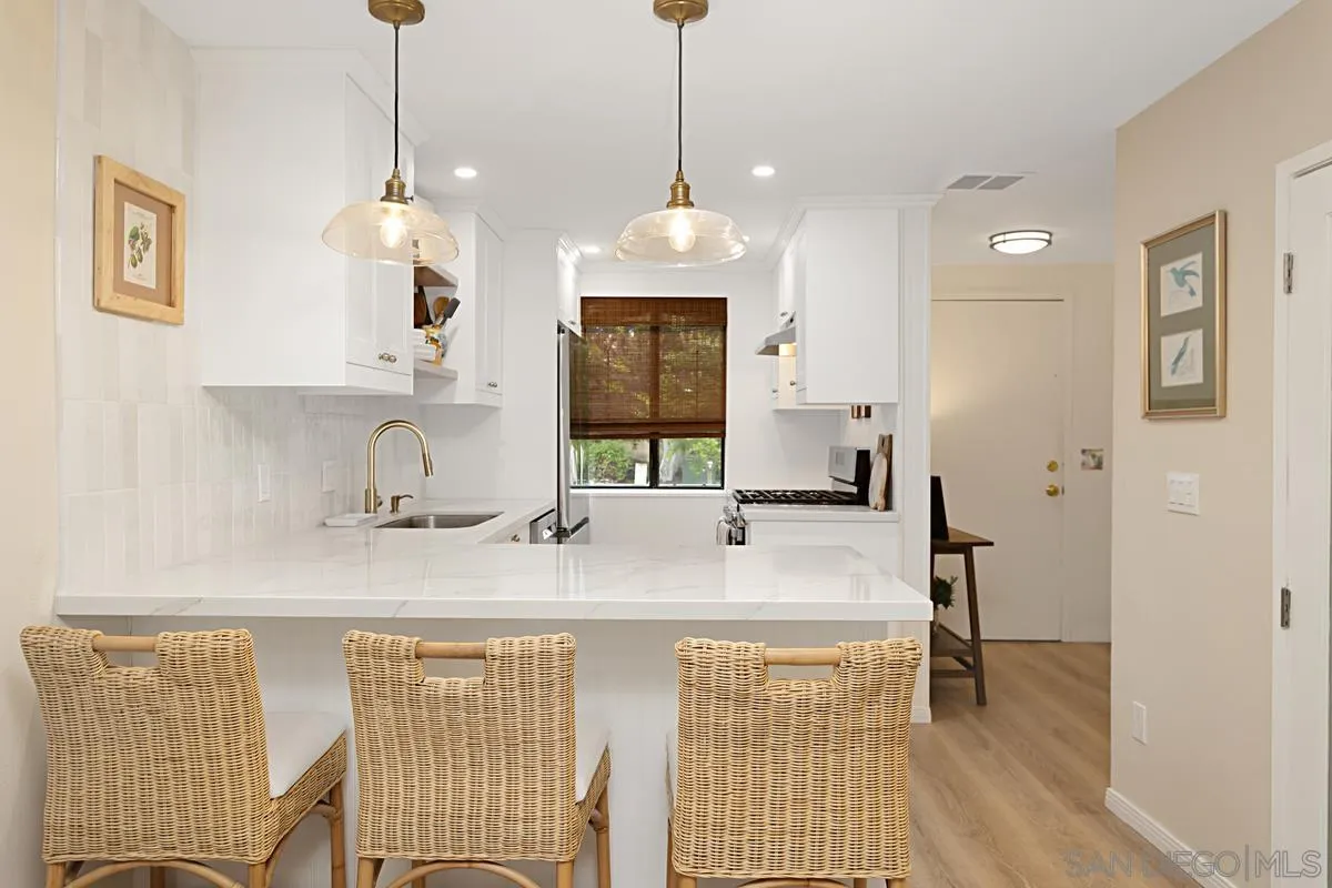 2383 Altisma Way, Unit B Carlsbad, CA 92009 - Photo 4 of 38 a view of a kitchen area with furniture and wooden floor