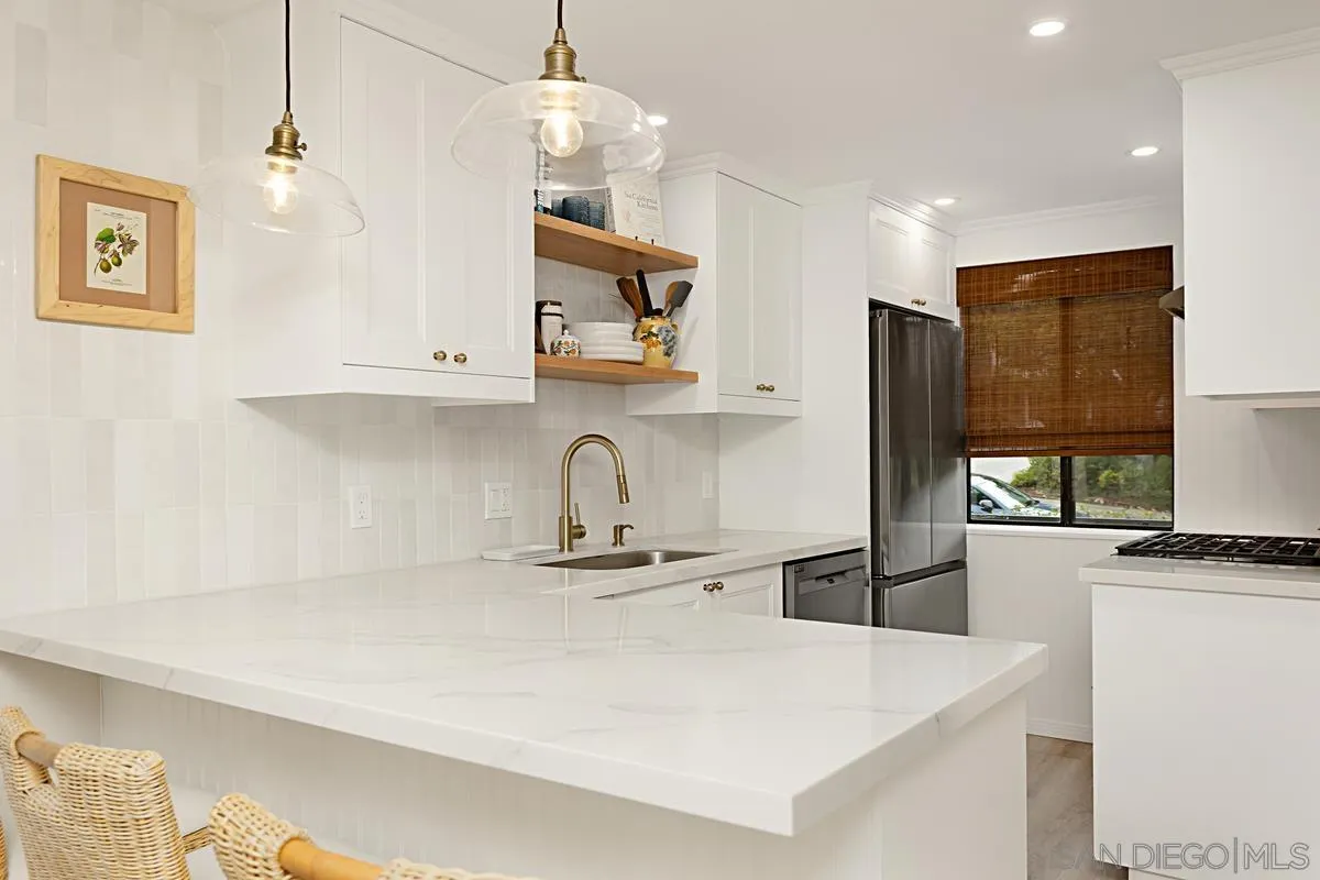 2383 Altisma Way, Unit B Carlsbad, CA 92009 - Photo 5 of 38 a kitchen with stainless steel appliances granite countertop a sink a stove and a refrigerator