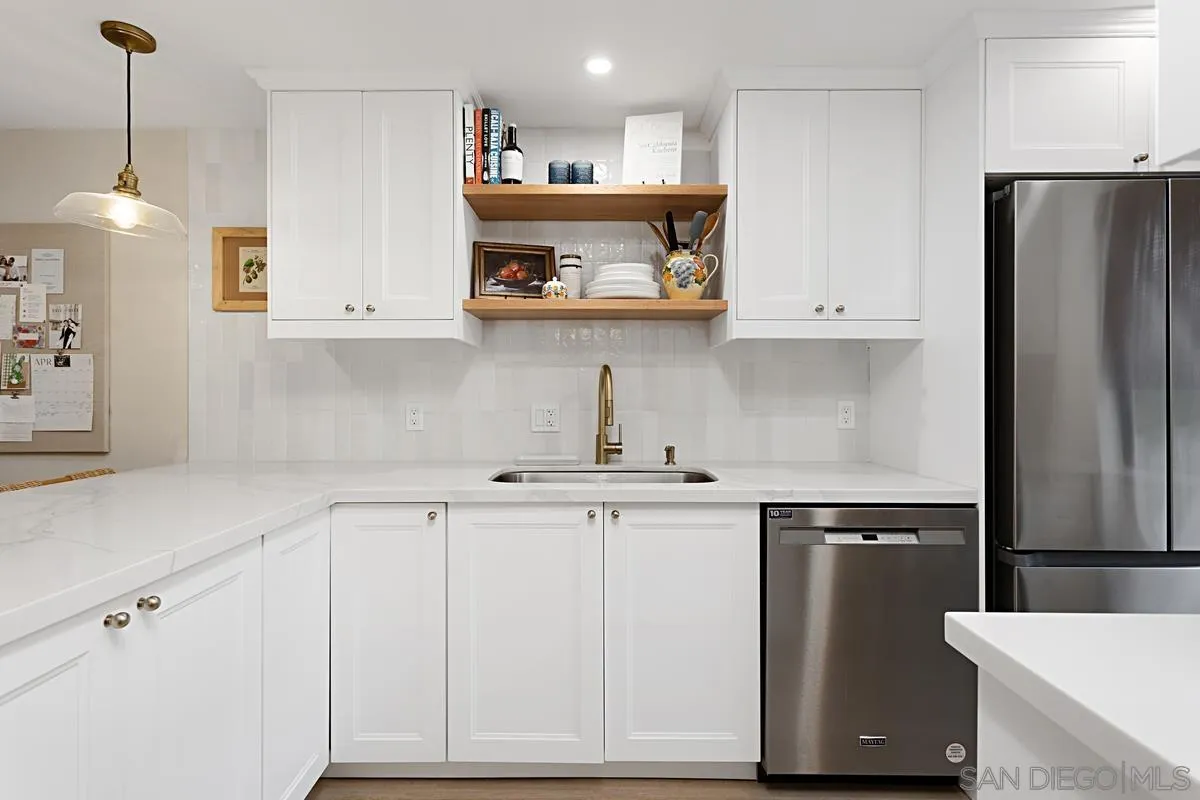 2383 Altisma Way, Unit B Carlsbad, CA 92009 - Photo 6 of 38 a kitchen with stainless steel appliances granite countertop a refrigerator a sink and a stove