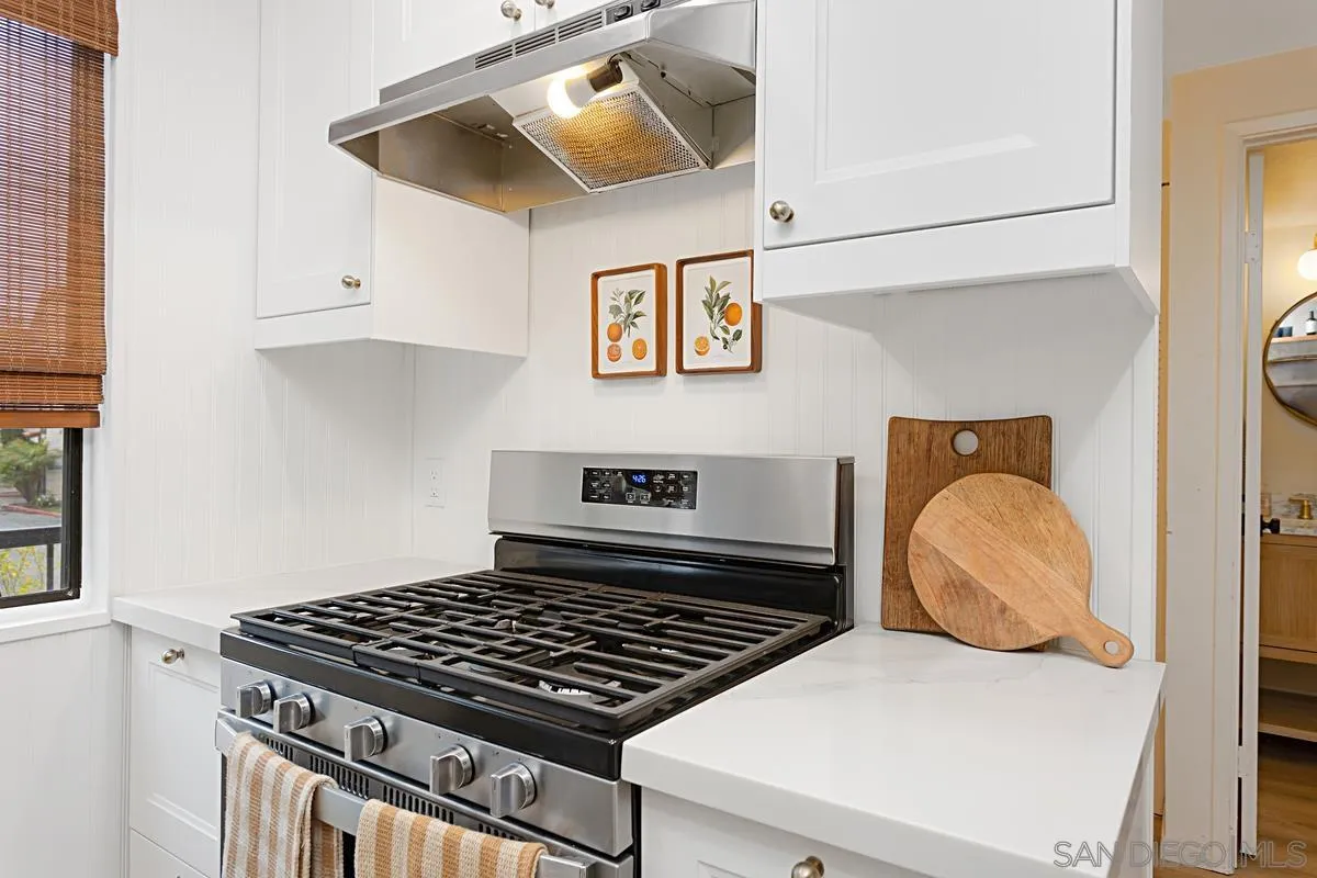 2383 Altisma Way, Unit B Carlsbad, CA 92009 - Photo 7 of 38 a kitchen with a stove and white cabinet