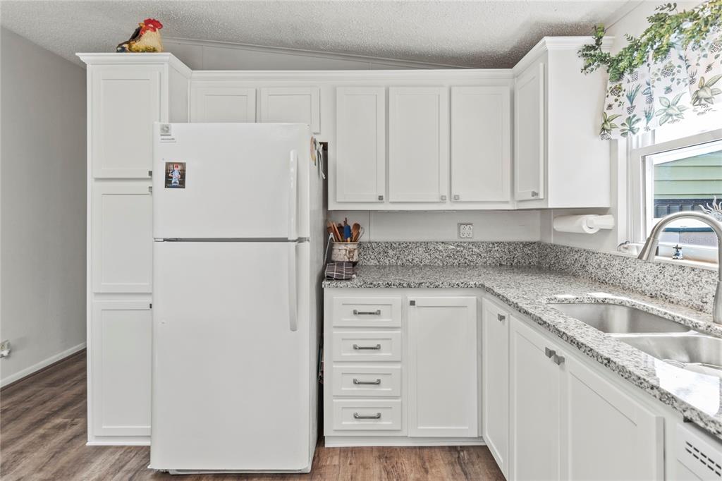 83 Eagle Circle Ellenton, FL 34222 - Photo 13 of 60 a white refrigerator freezer sitting inside of a kitchen