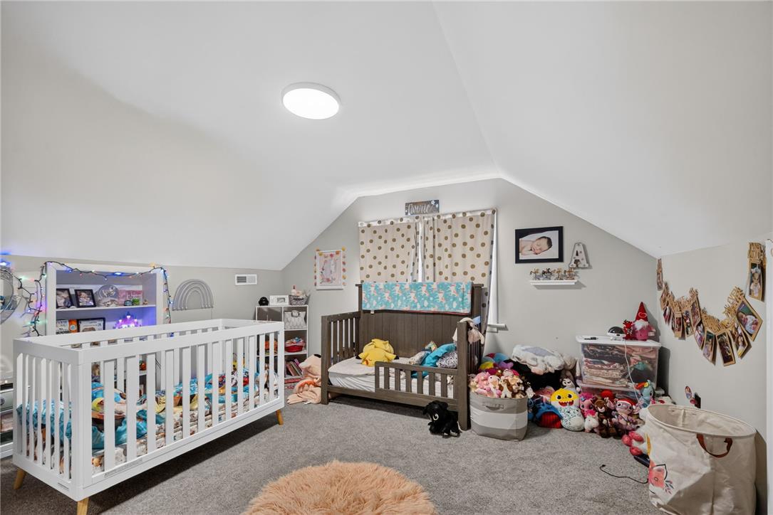 3123 Orefield Road Allentown, PA 18104 - Photo 31 of 39 A charming bedroom under a vaulted ceiling offers a comfortable space with soft carpet.