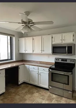 a kitchen with stainless steel appliances a stove sink and cabinets
