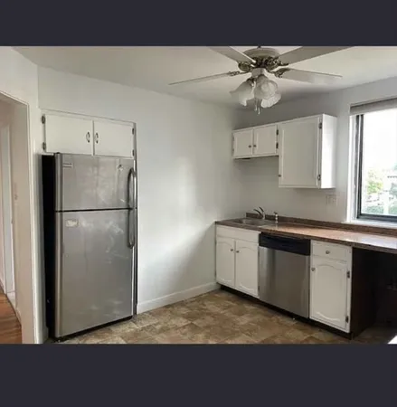 a kitchen with a refrigerator and a sink