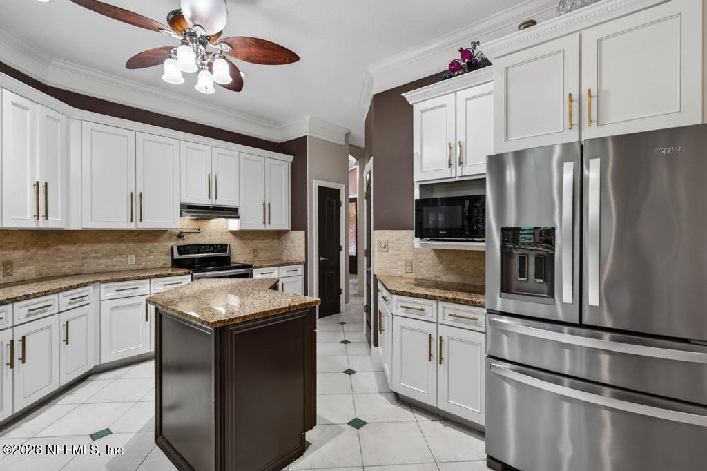 1483 Bridgette Way Fleming Island, FL 32003 - Photo 17 of 63 a kitchen with cabinets stainless steel appliances and a counter space