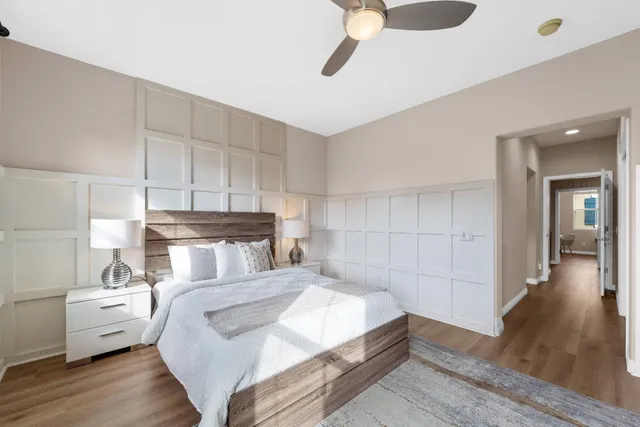 a bedroom with a bed and a chandelier