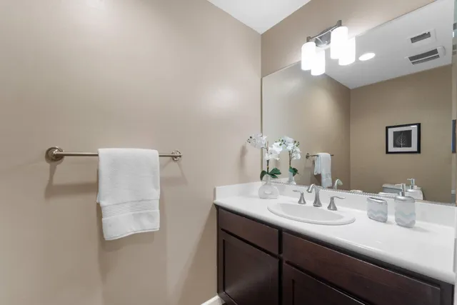 a bathroom with a sink vanity and a mirror