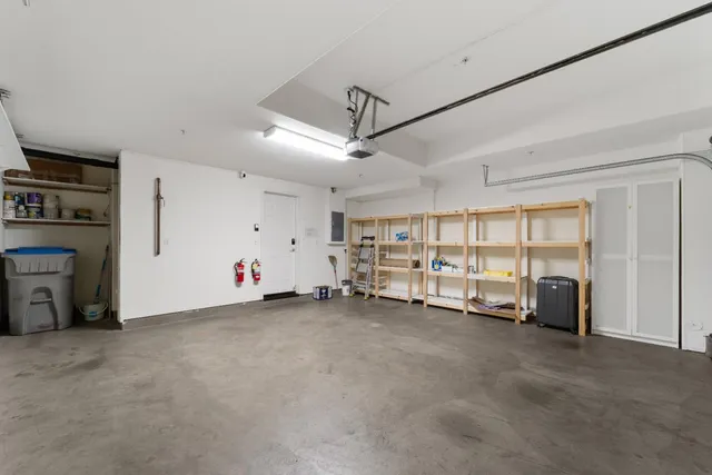 a view of an empty room with a fireplace and a window