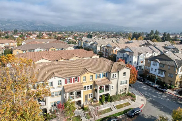 an aerial view of residential houses with outdoor space