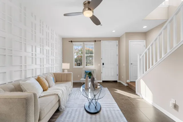 a living room with furniture and a chandelier