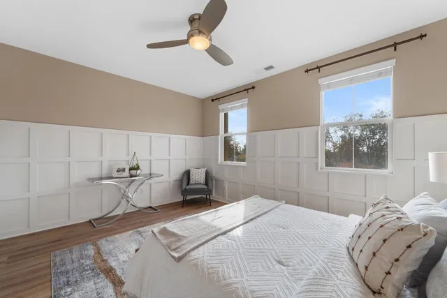 a bedroom with a bed and a chandelier