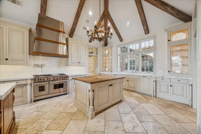 a dining room with furniture a chandelier and wooden floor