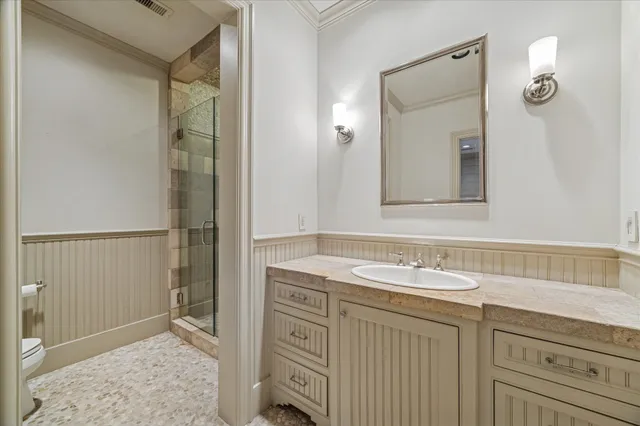 a bathroom with a granite countertop sink a mirror a bathtub and shower