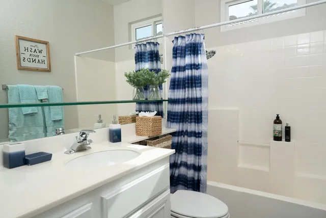 a bathroom with a sink toilet and shower