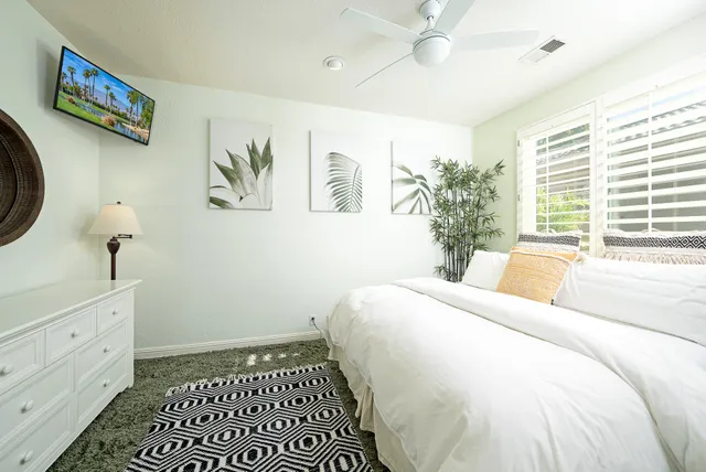 a bedroom with a large bed and a window