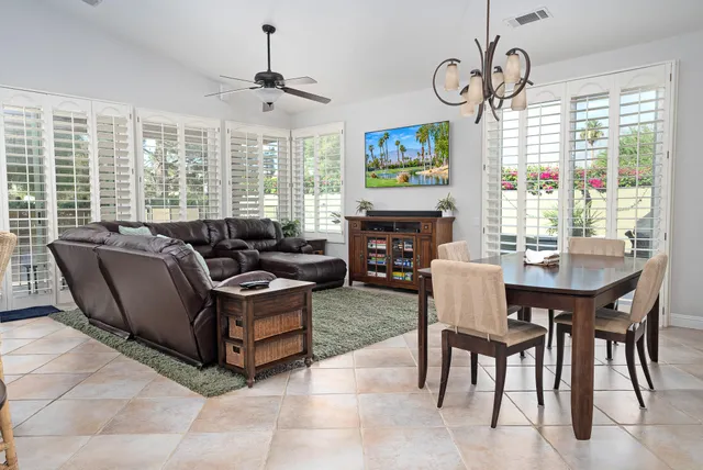 a living room with fireplace furniture and a flat screen tv