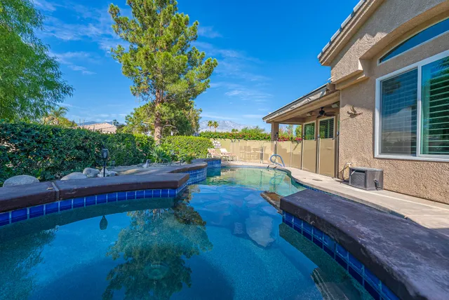 a view of a backyard with sitting area