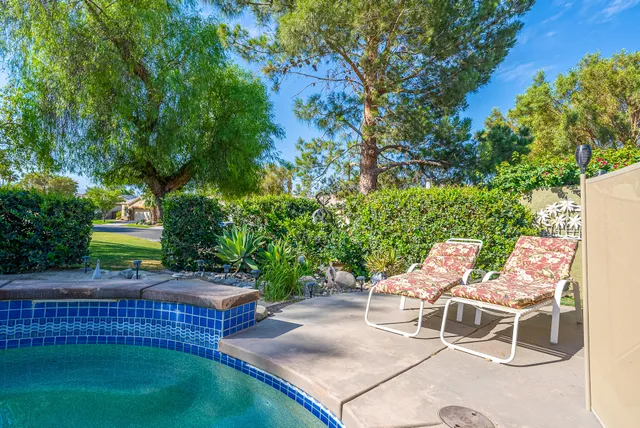a view of a chairs and table in backyard