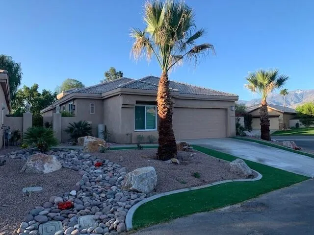 a view of a house with a yard and a garden