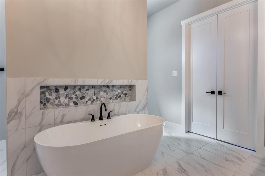555 Aermotor Loop Weatherford, TX 76085 - Photo 26 of 30 a white bath tub sitting in a bathroom
