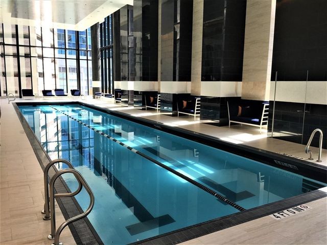 a bathroom with a glass shower door