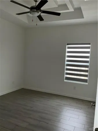 a view of a room with wooden floor and a window