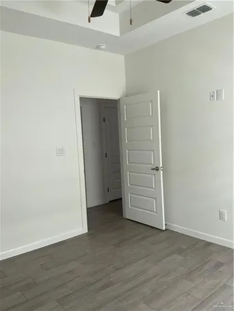 an empty room with wooden floor