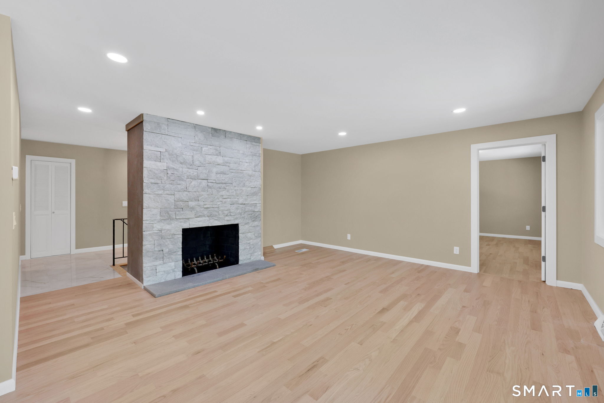 49 Millstone Road Glastonbury, CT 06033 - Photo 7 of 39 an empty room with wooden floor and fireplace