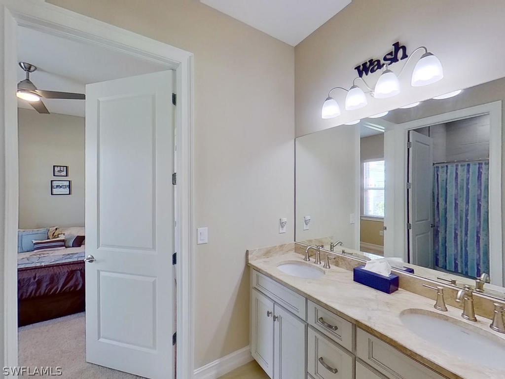 8920 Rails End Court Fort Myers, FL 33919 - Photo 13 of 35 a bathroom with a double vanity sink and a mirror