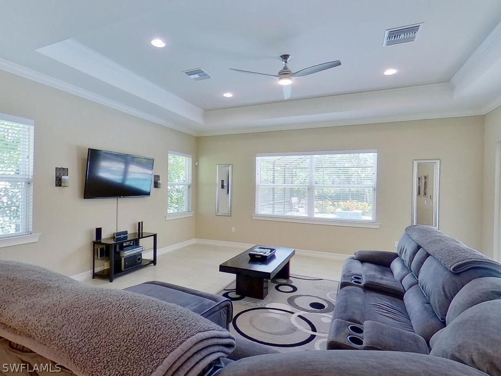 8920 Rails End Court Fort Myers, FL 33919 - Photo 17 of 35 a living room with furniture a flat screen tv and a window