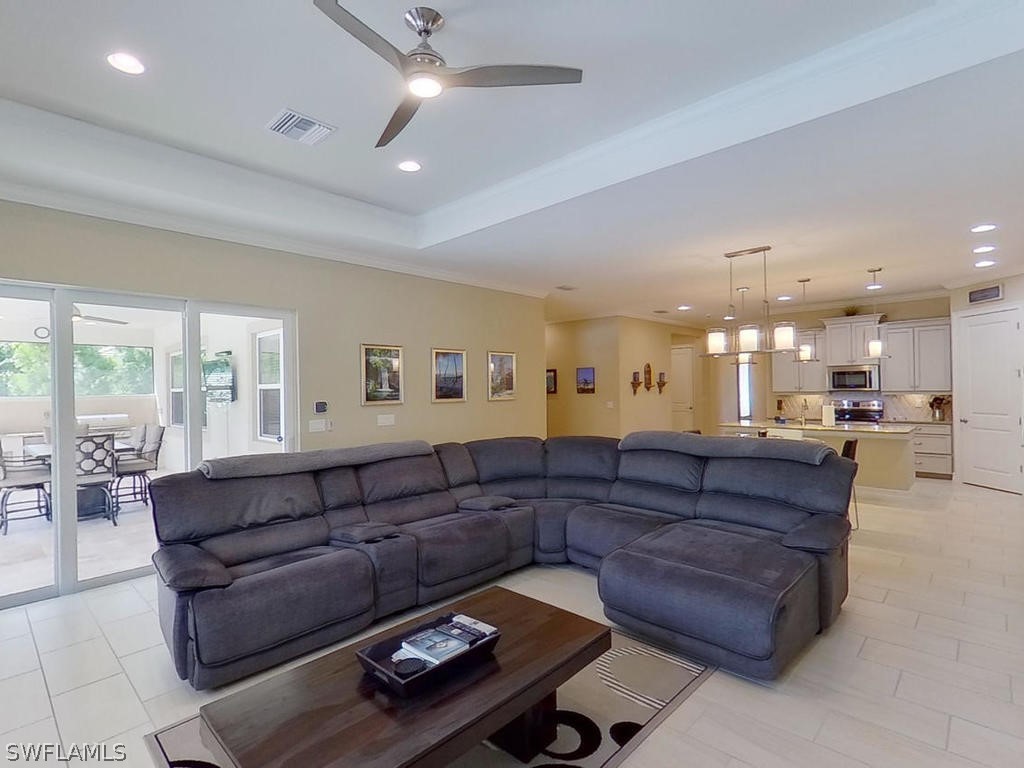 8920 Rails End Court Fort Myers, FL 33919 - Photo 18 of 35 a living room with a couch and a view of kitchen