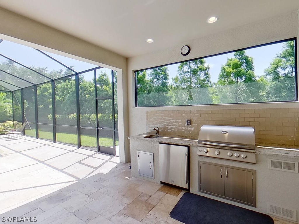 8920 Rails End Court Fort Myers, FL 33919 - Photo 20 of 35 a kitchen with a stove and a view of living room