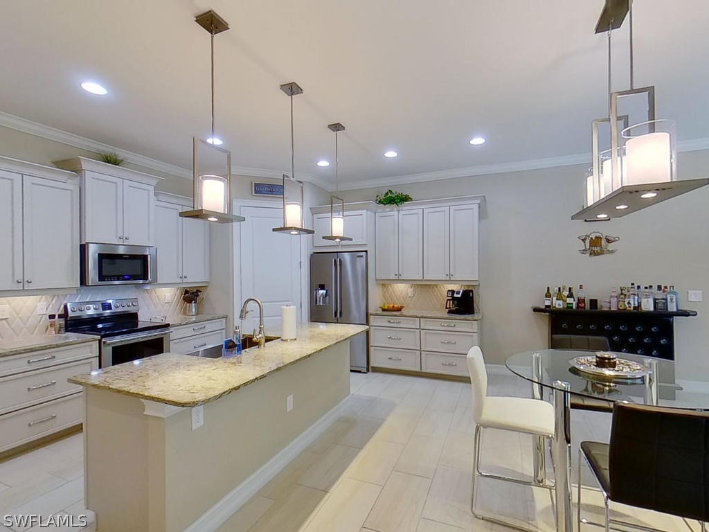 8920 Rails End Court Fort Myers, FL 33919 - Photo 5 of 35 a kitchen with a sink a counter and cabinets