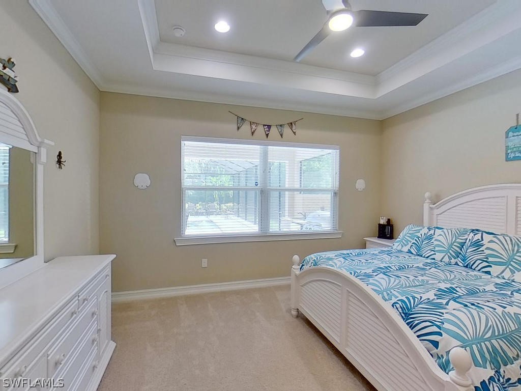 8920 Rails End Court Fort Myers, FL 33919 - Photo 8 of 35 a bedroom with a bed and a large window