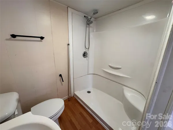 an empty room with walk in closet and a window