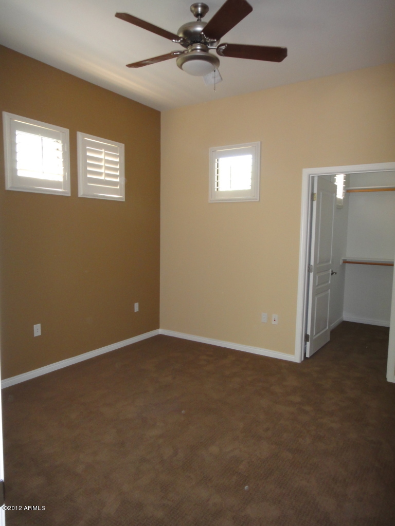 4488 East Thomas Road, Unit 1018 Phoenix, AZ 85018 - Photo 10 of 14 an empty room with windows and closet