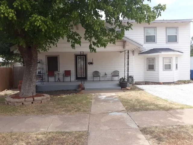 a view of a house with backyard and sitting area