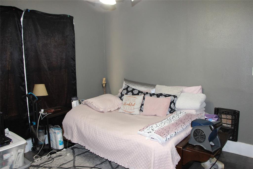 503 West 9th Street Cisco, TX 76437 - Photo 5 of 9 a bed sitting in a bedroom next to a bathroom