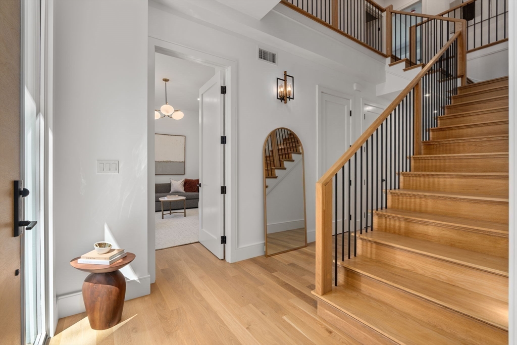 470 Quinobequin Road Newton, MA 02468 - Photo 3 of 37 a view of a hallway with wooden floor and entryway