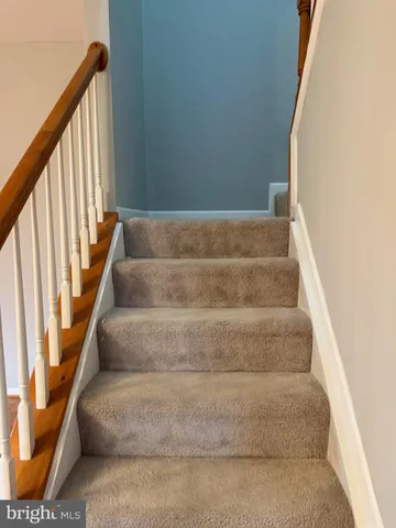 a view of staircase with white walls