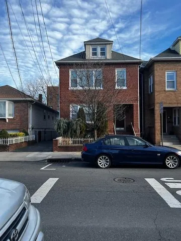 a front view of a house with parking area
