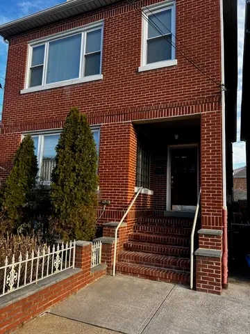 a front view of a house with iron fence
