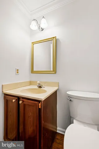 a bathroom with a toilet a sink and mirror