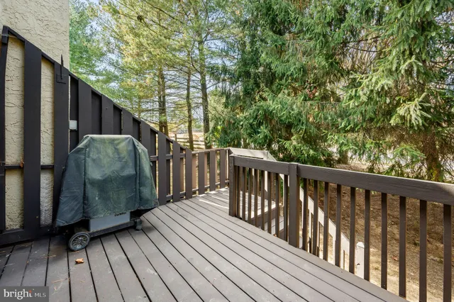 a view of balcony with wooden floor and fence